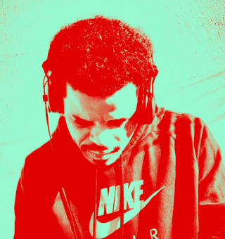 Tony Diaz with headphones, singing into a microphone during a live music performance.