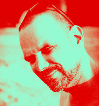 Close-up of Thoreg with a confident expression, red-inked image.