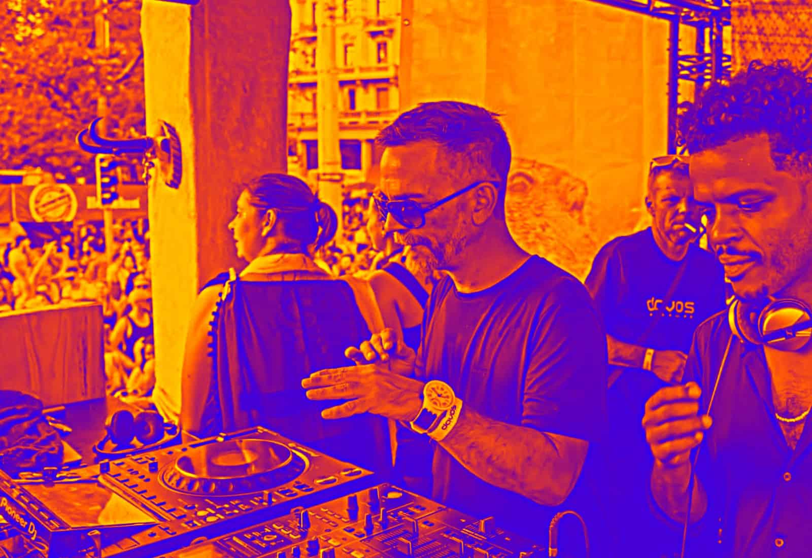 DJ performing at BudenMusik event with crowd in background.