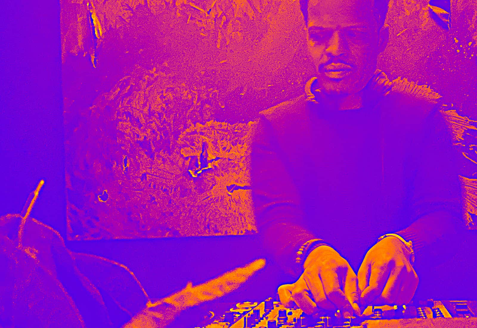 DJ mixing music at BudenMusik event with vibrant lighting.